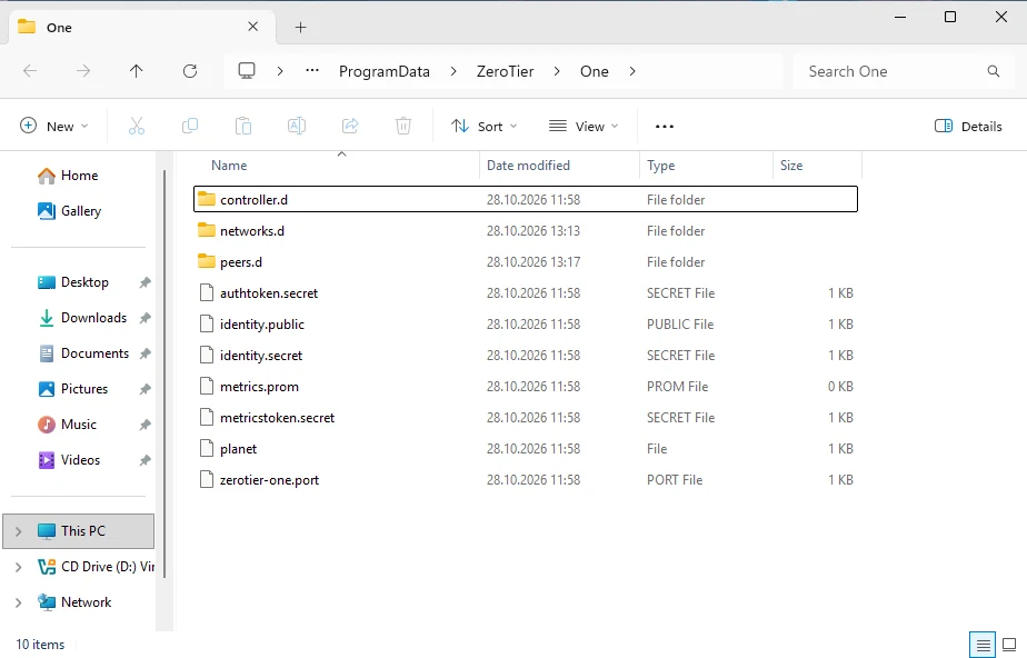 Windows File Explorer showing C:\ProgramData\ZeroTier\One after uninstalling, still containing identity.secret, authtoken.secret, metricstoken.secret, networks.d and peers.d